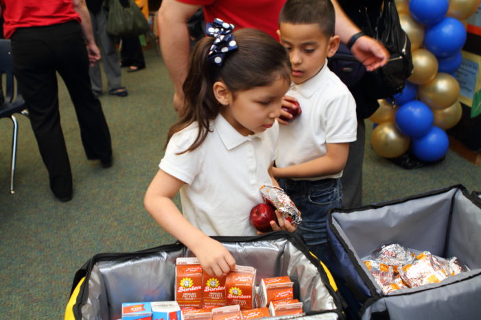 Elementary students pick out their breakfasts in the classroom.