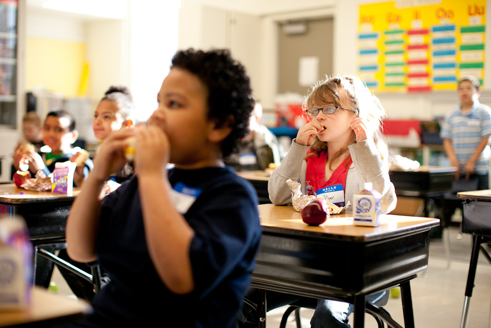 Elementary students eat their in classroom breakfast